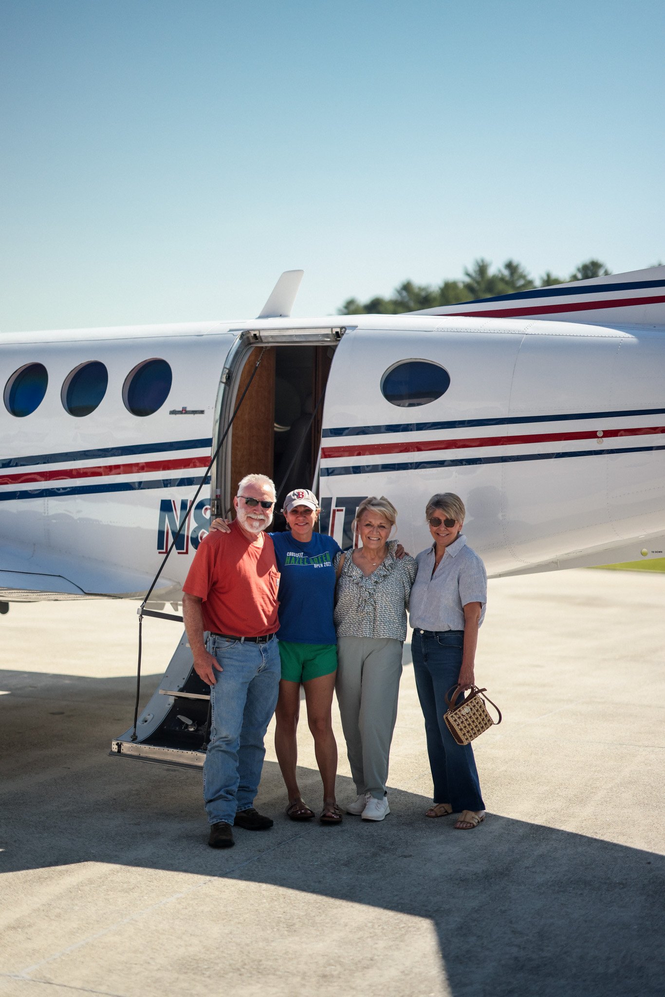 Friends gathered at the airstair of a King Air